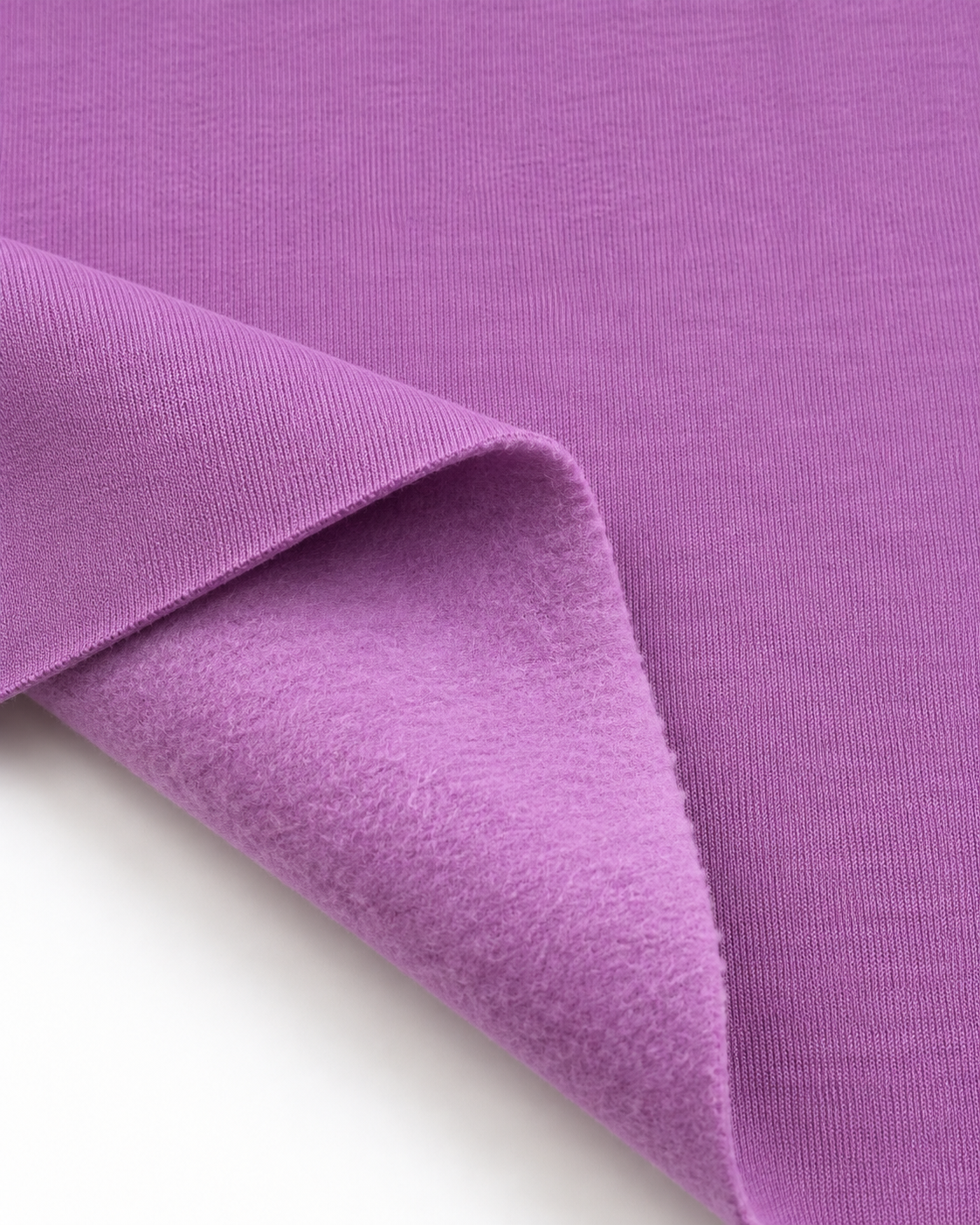 Lavender brushed fleece fabric showing a smooth outer surface and soft fleece on the inside.