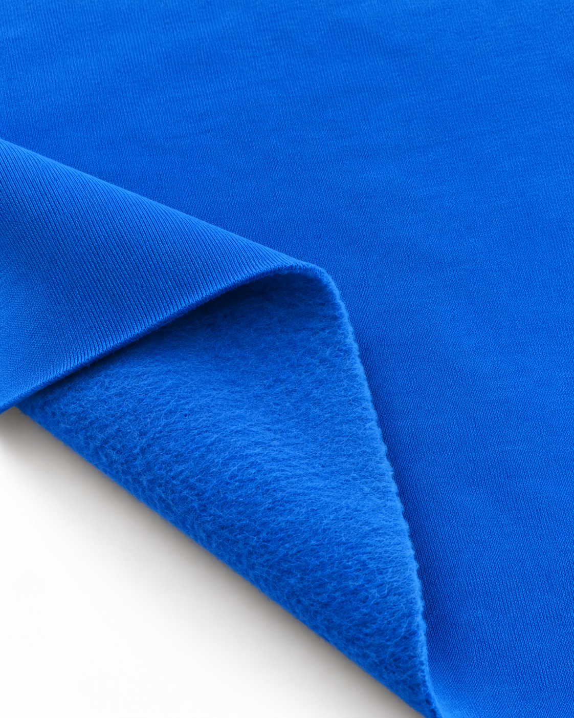 Blue brushed fleece fabric showing a smooth outer surface and soft fleece on the inside.