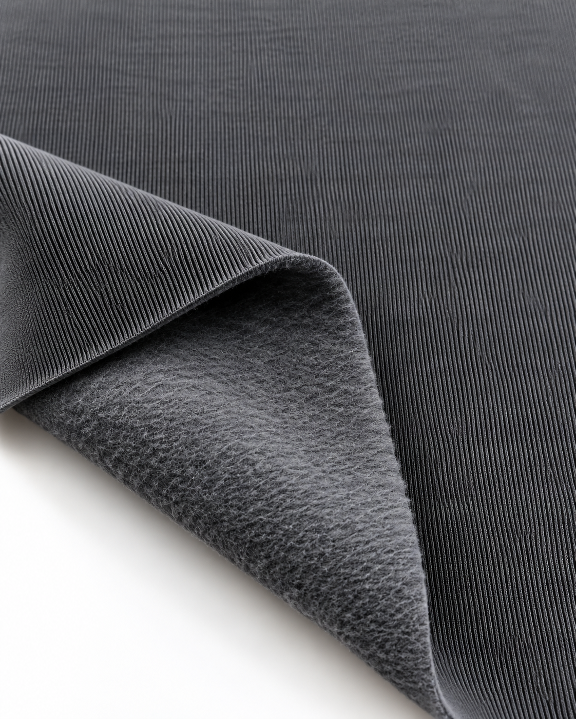 Iron grey brushed fleece fabric showing a smooth outer surface and soft fleece on the inside.
