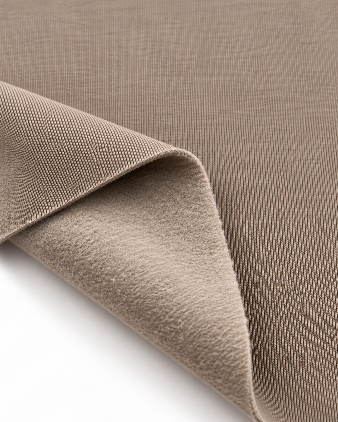 Latte brushed fleece fabric showing a smooth outer surface and soft fleece on the inside.