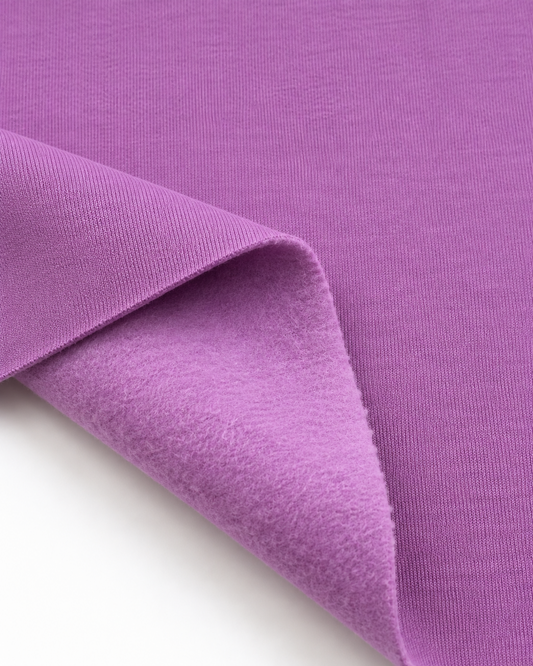 Lavender brushed fleece fabric showing a smooth outer surface and soft fleece on the inside.