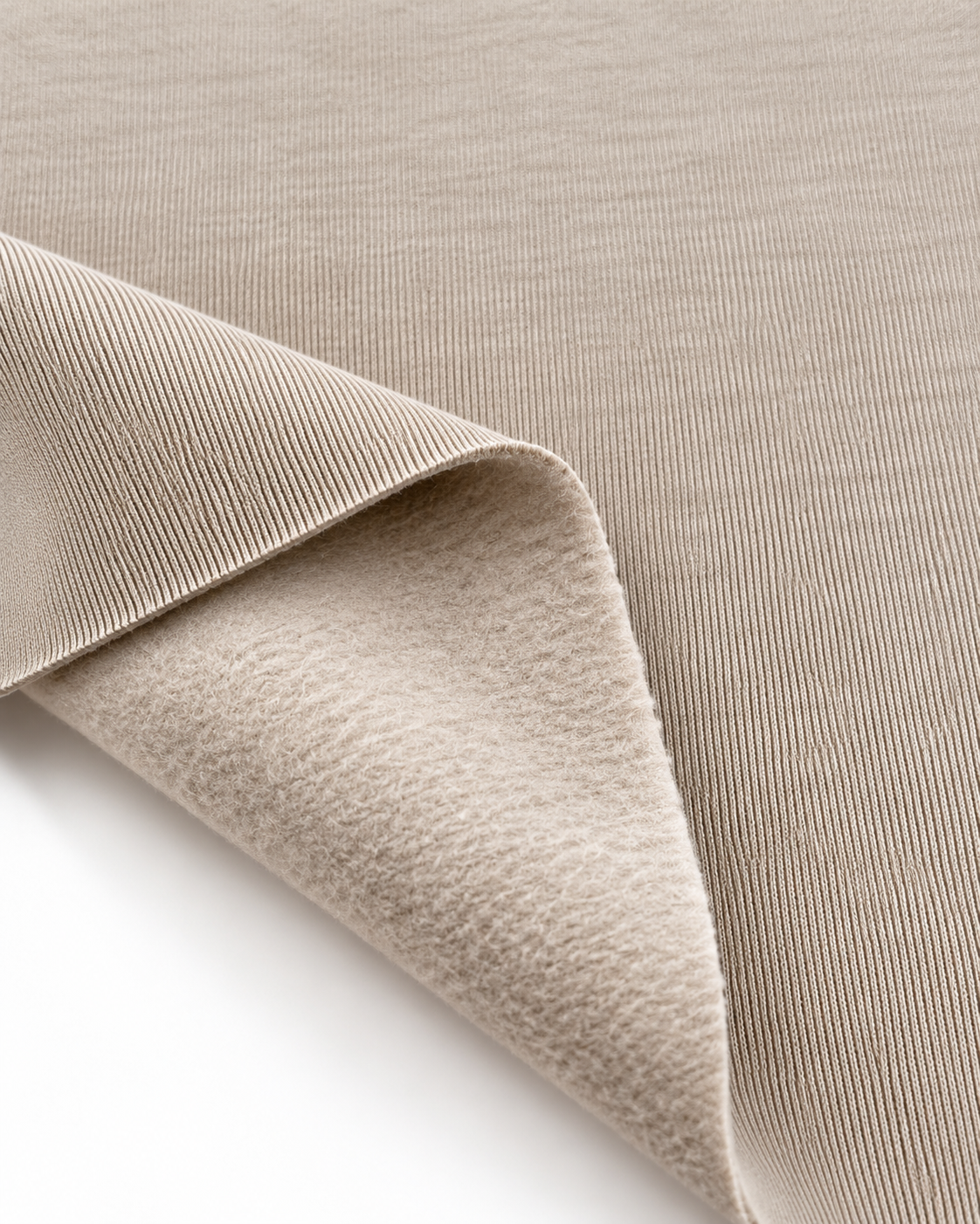 Light beige brushed fleece fabric showing a smooth outer surface and soft fleece on the inside.