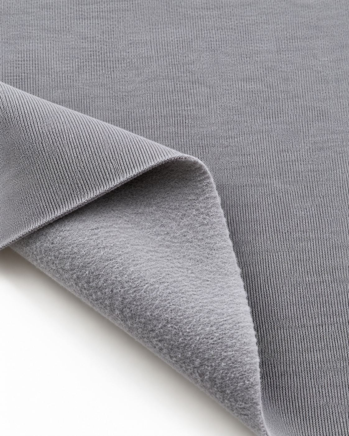Light grey brushed fleece fabric showing a smooth outer surface and soft fleece on the inside.