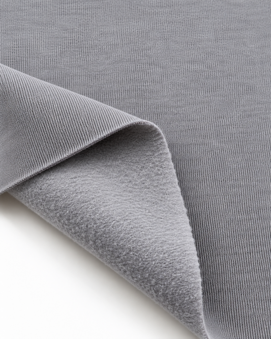 Light grey brushed fleece fabric showing a smooth outer surface and soft fleece on the inside.