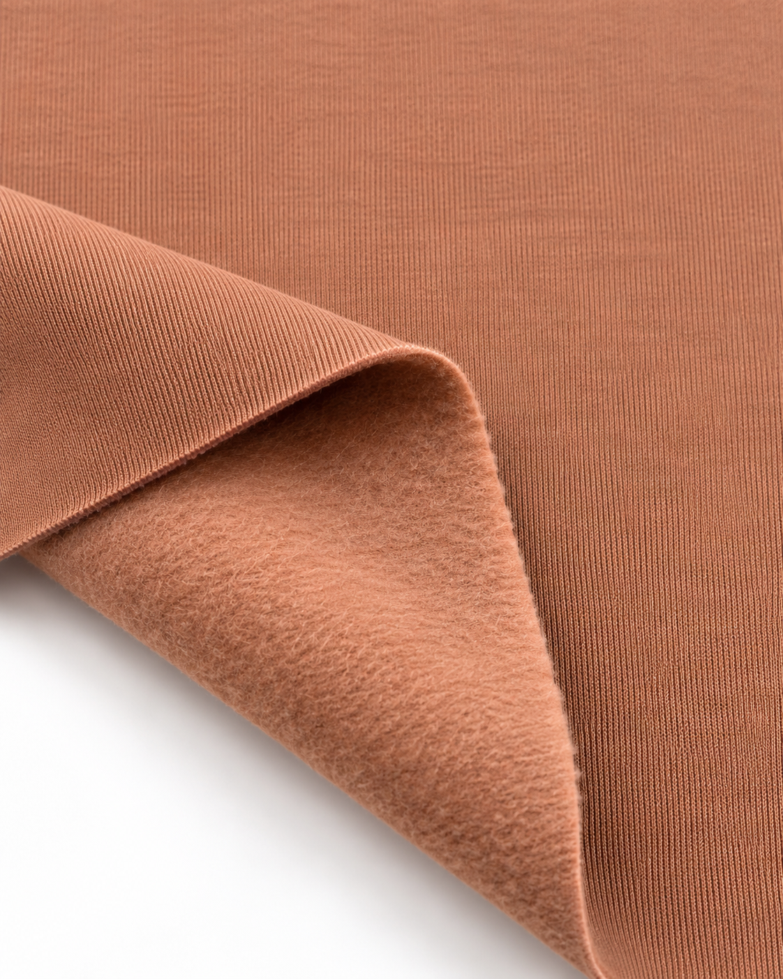 Mocha Mousse brushed fleece fabric showing a smooth outer surface and soft fleece on the inside.