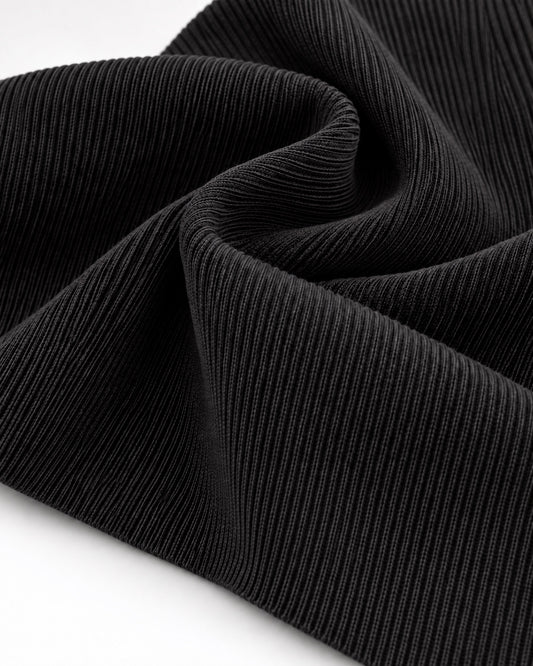 Black rib knit fabric showing fine vertical ribs and a dense elastic texture.