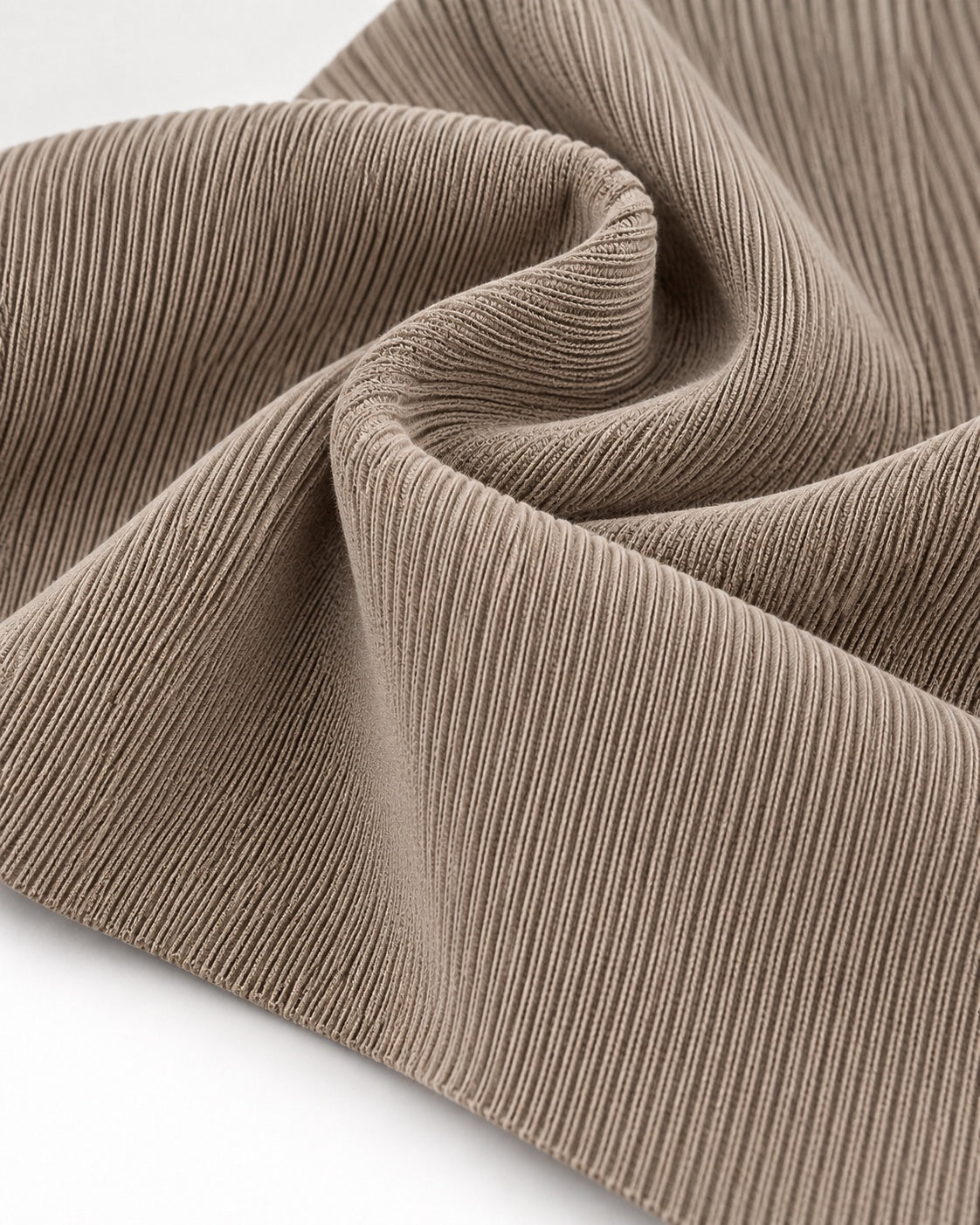 Light beige rib knit fabric showing fine vertical ribs and a dense elastic texture.