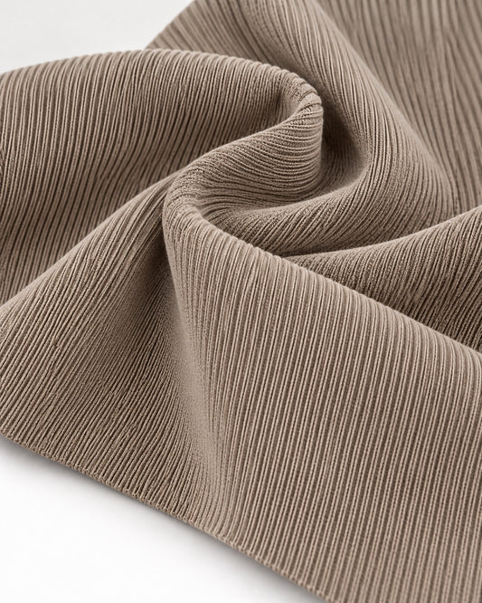 Light beige rib knit fabric showing fine vertical ribs and a dense elastic texture.